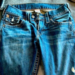 2 pairs of true religion denim jeans one pair is black the other pair blue